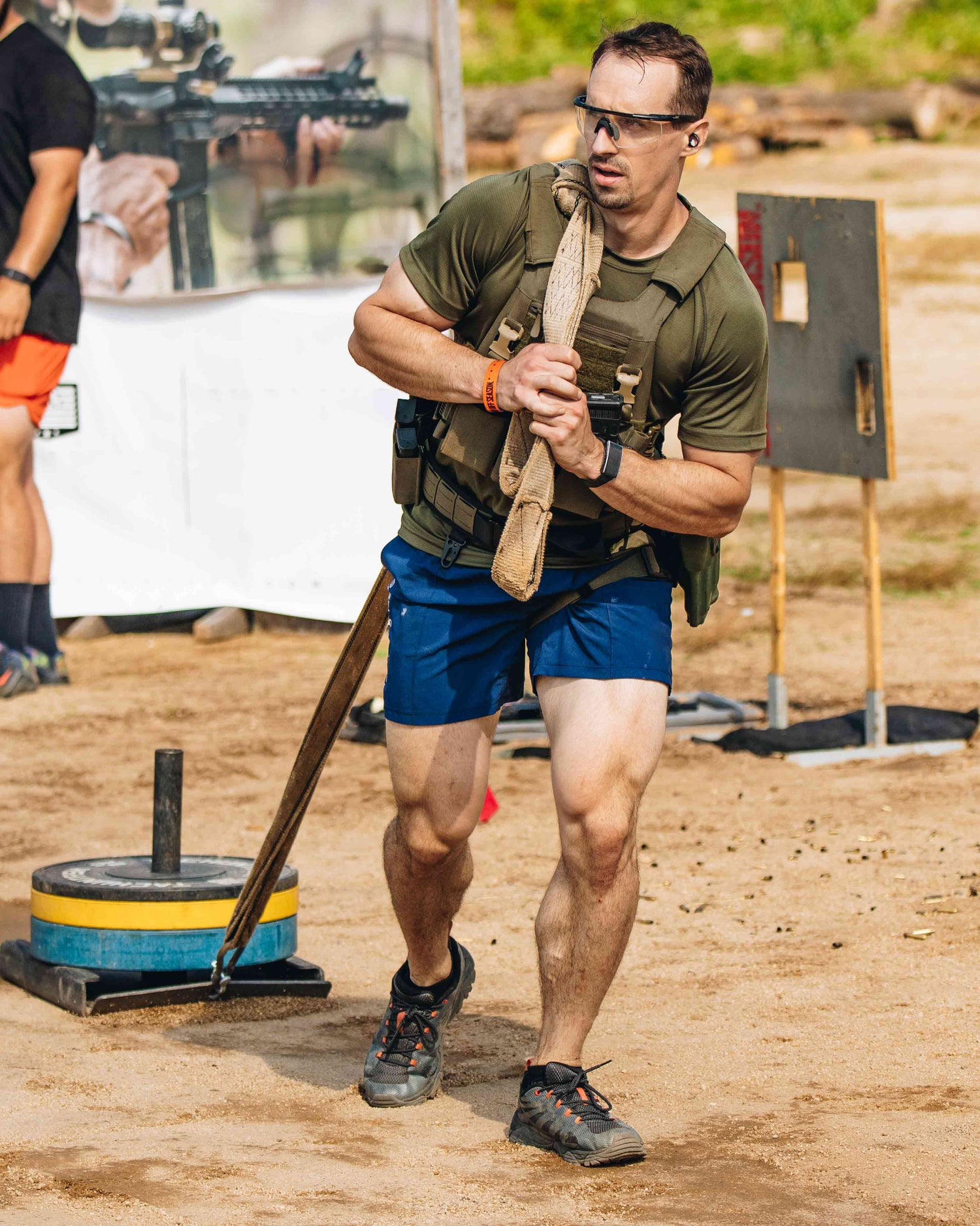 Andrew Smallman dragging a weighted sled wearing weighted vest.  